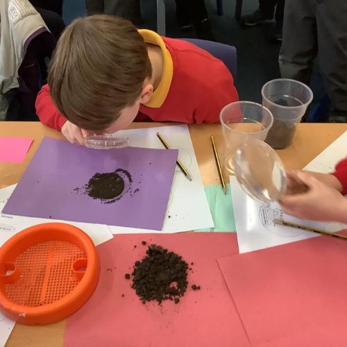 Helvellyn explored soil with magnifying glasses and sieves to find out what it is made of.